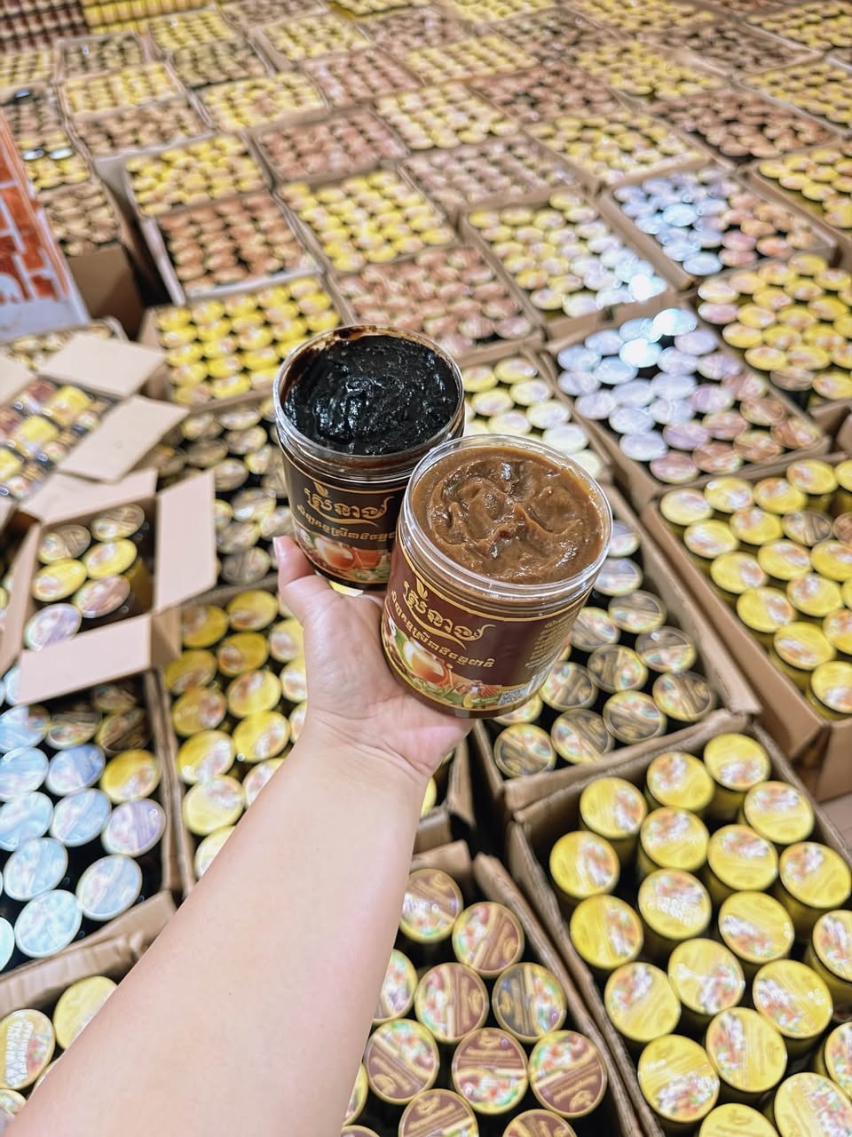 Open jars of coffee and tamarind scrub